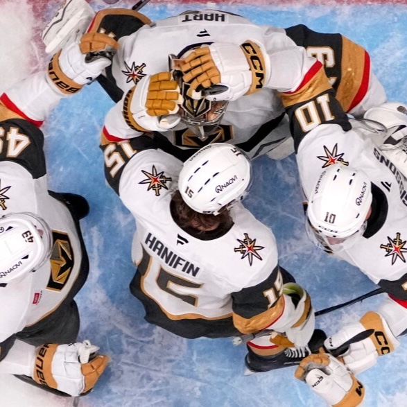 Vegas Golden Knights players huddled together on the ice, seen from above